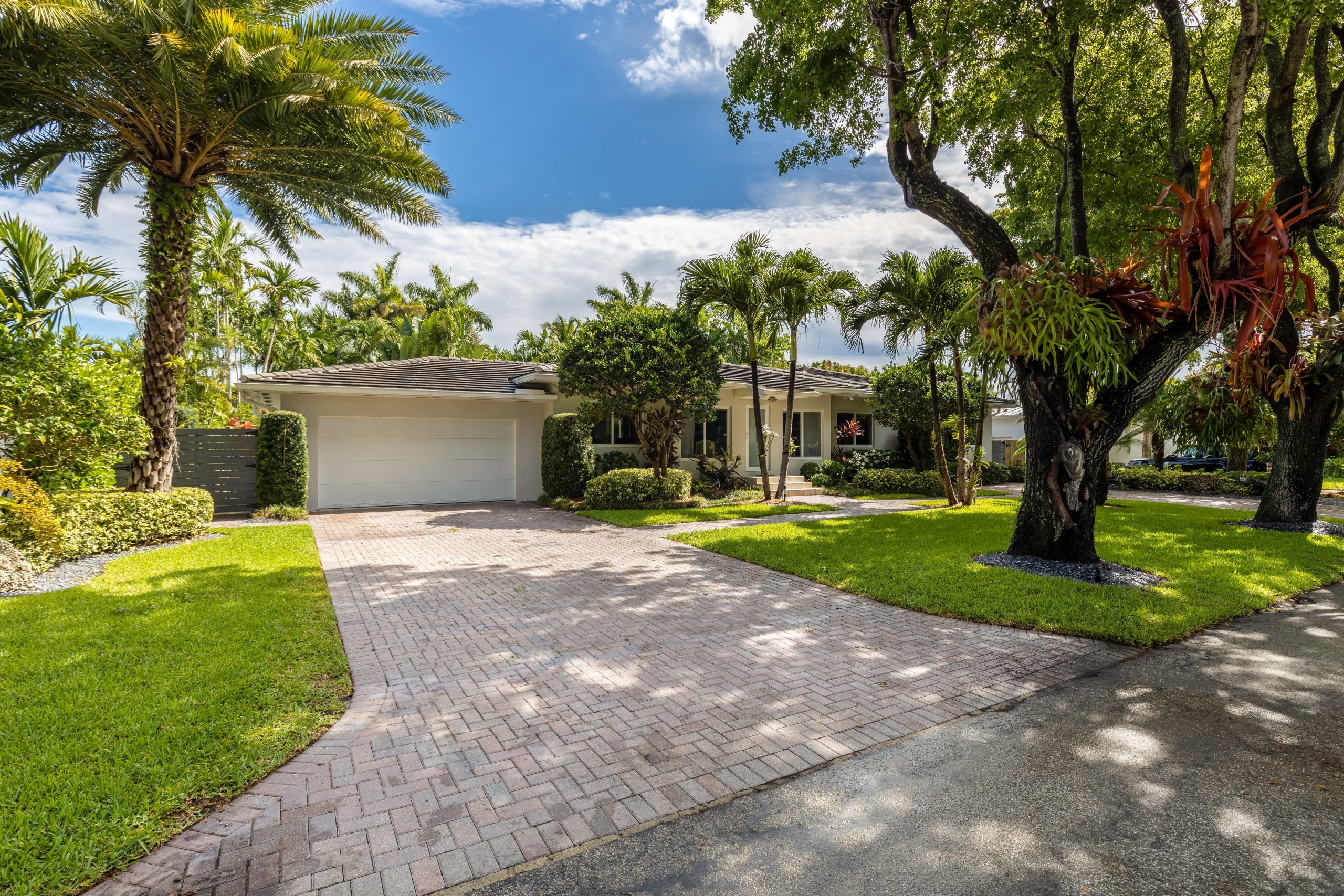 A beautifully laid cobblestone driveway with a herringbone pattern.