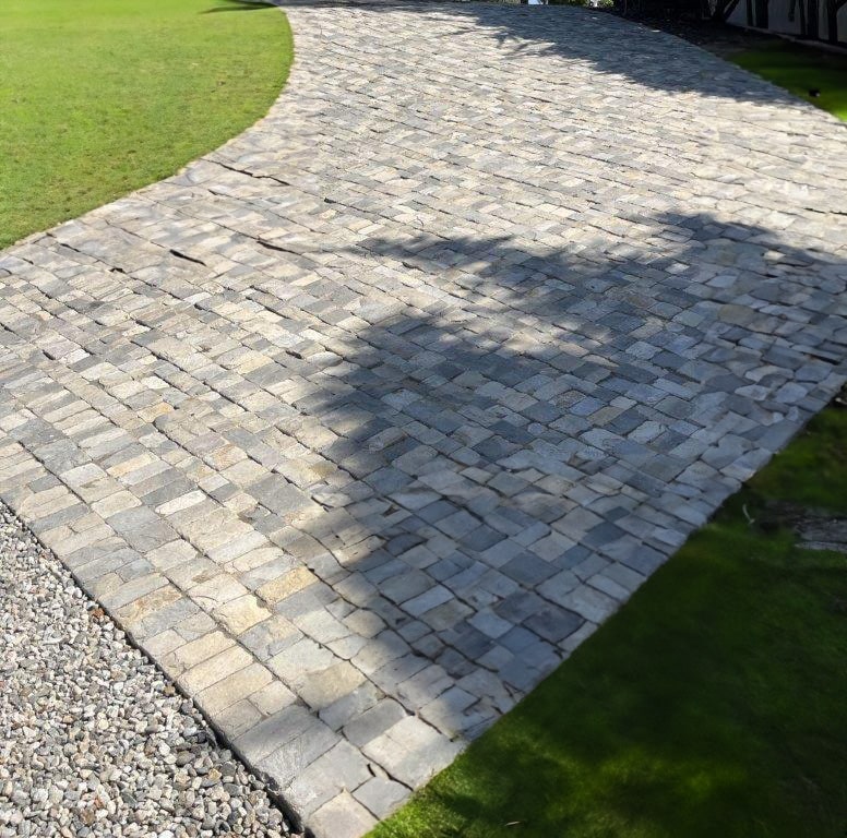 Cobblestone walkway maintained and weed-free in a garden