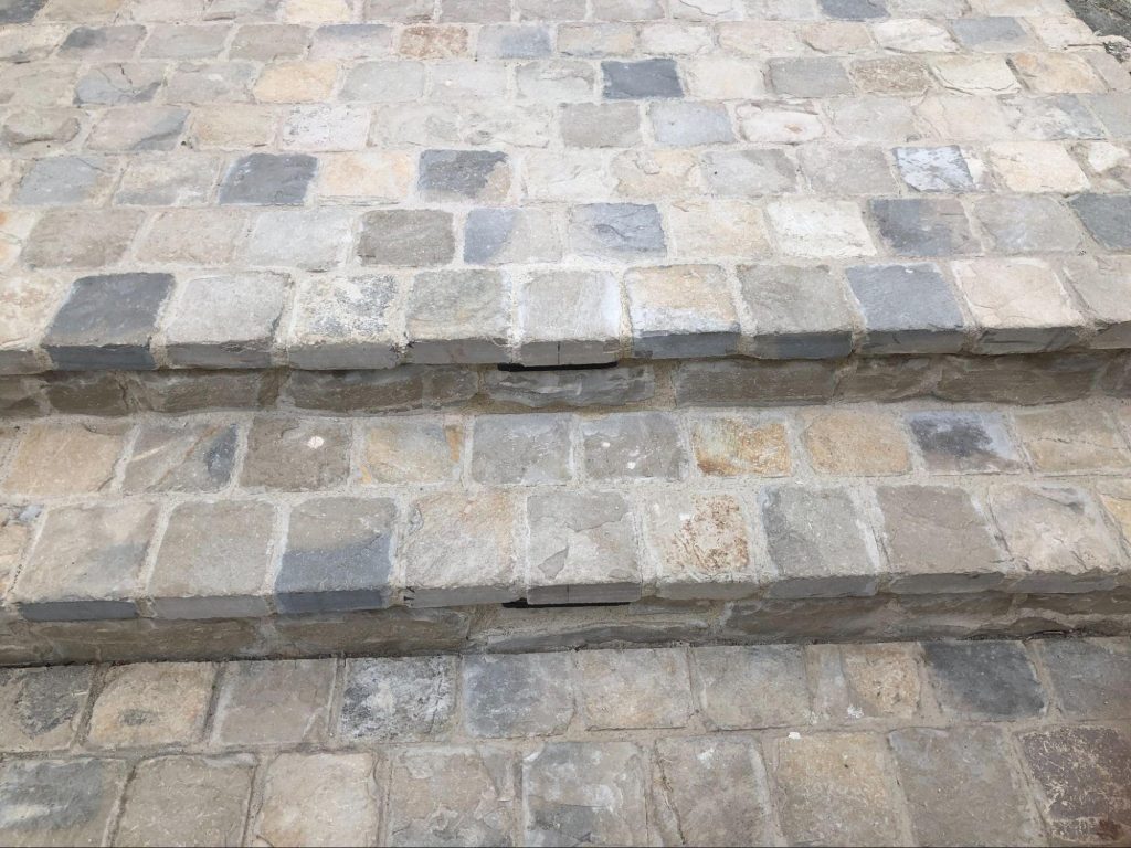 Cobblestone walkway maintained and weed-free in a garden